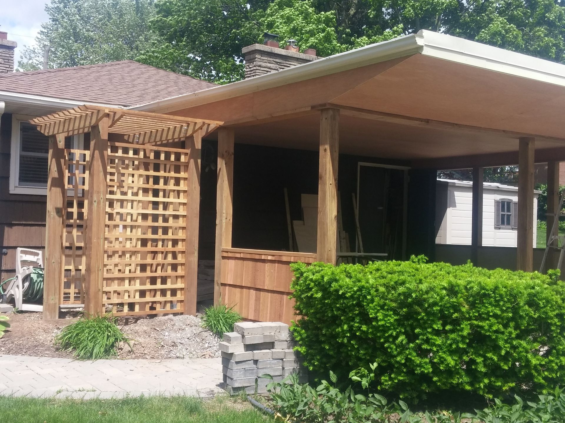A house with a wooden pergola on the front porch