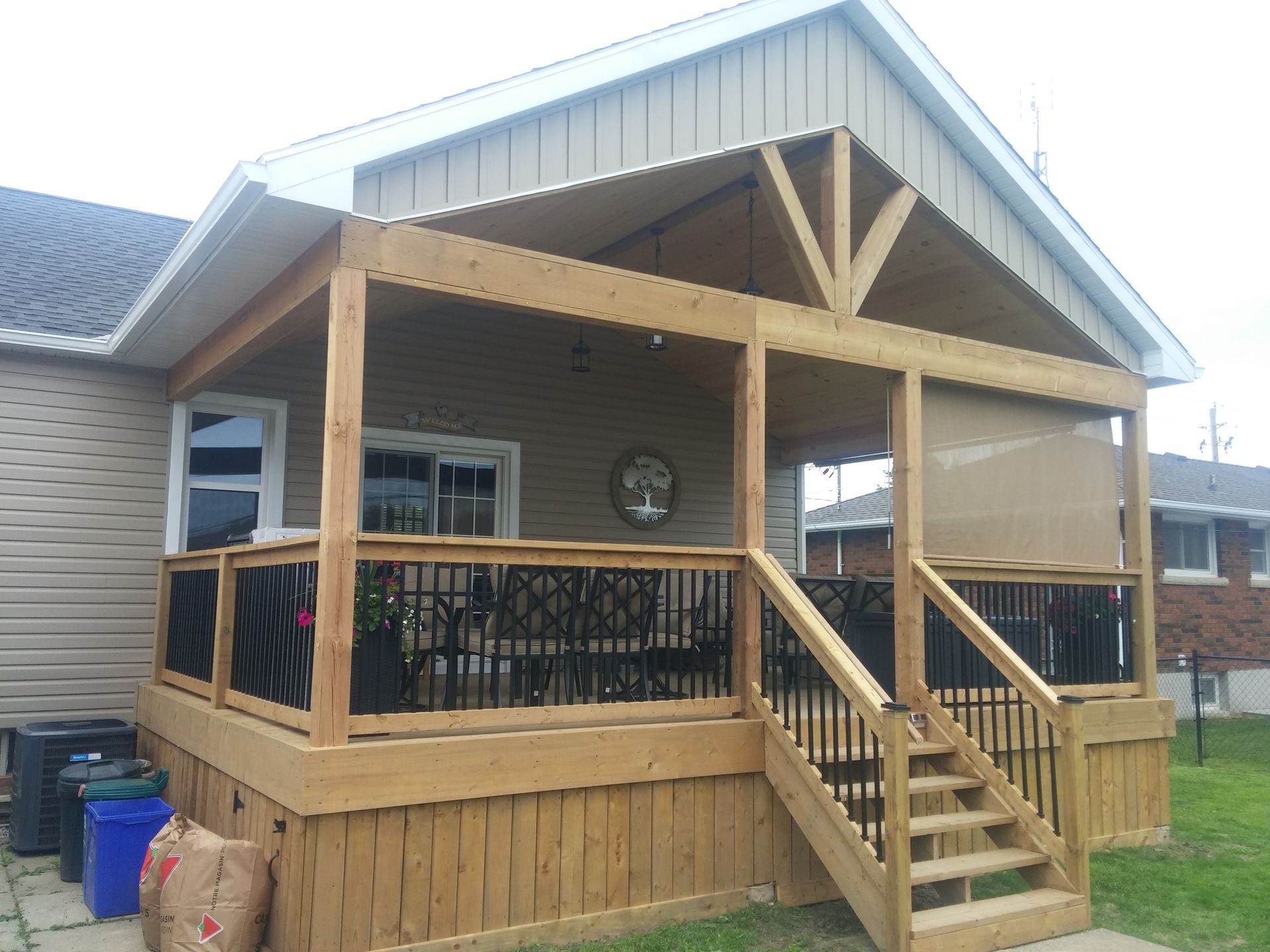 A house with a screened in porch and stairs