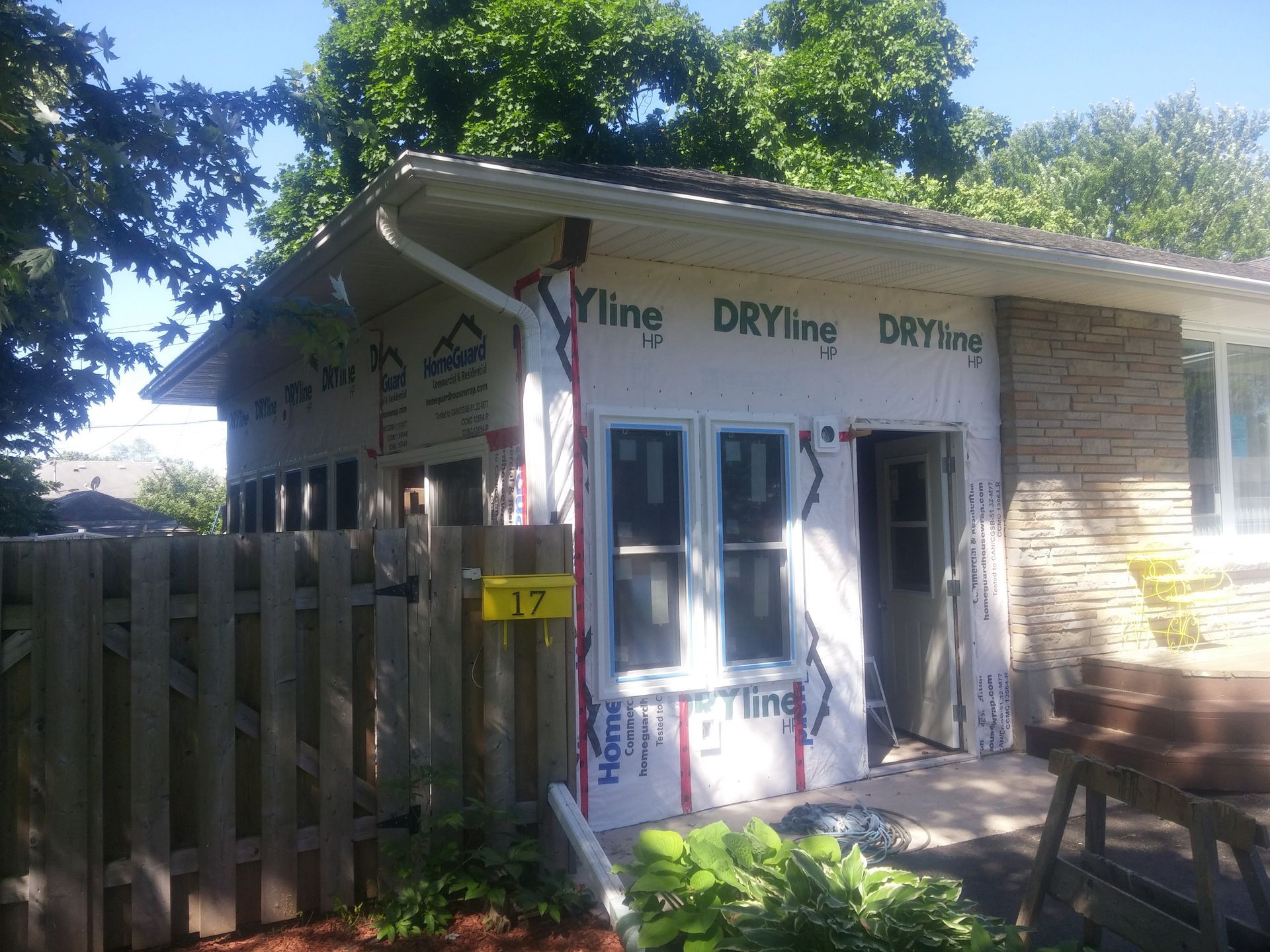 A house that is being remodeled with a sign that says 17
