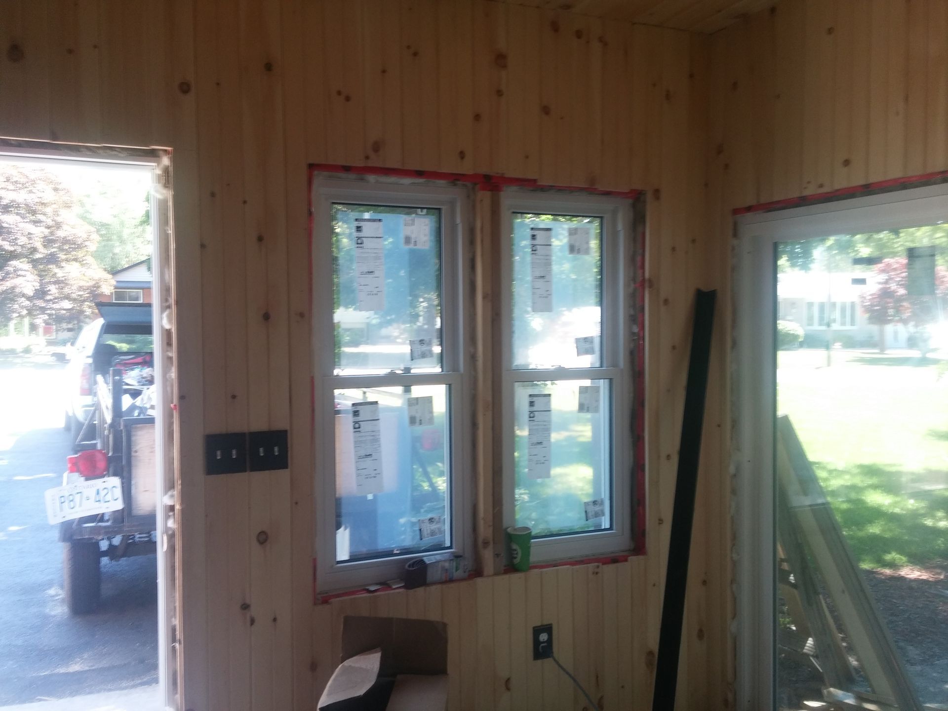 A jeep is parked in the driveway of a house under construction