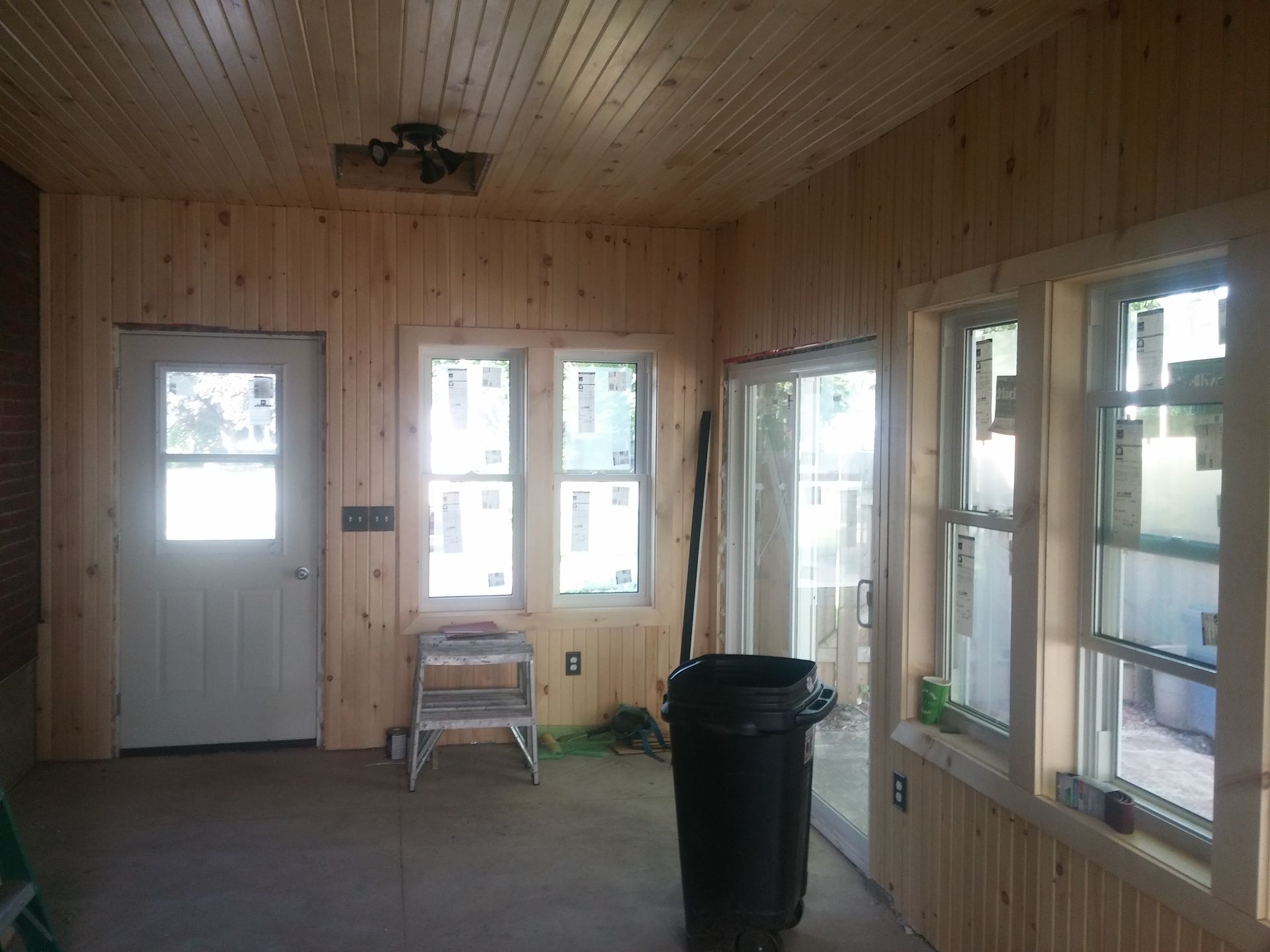 There is a trash can in the middle of the room.