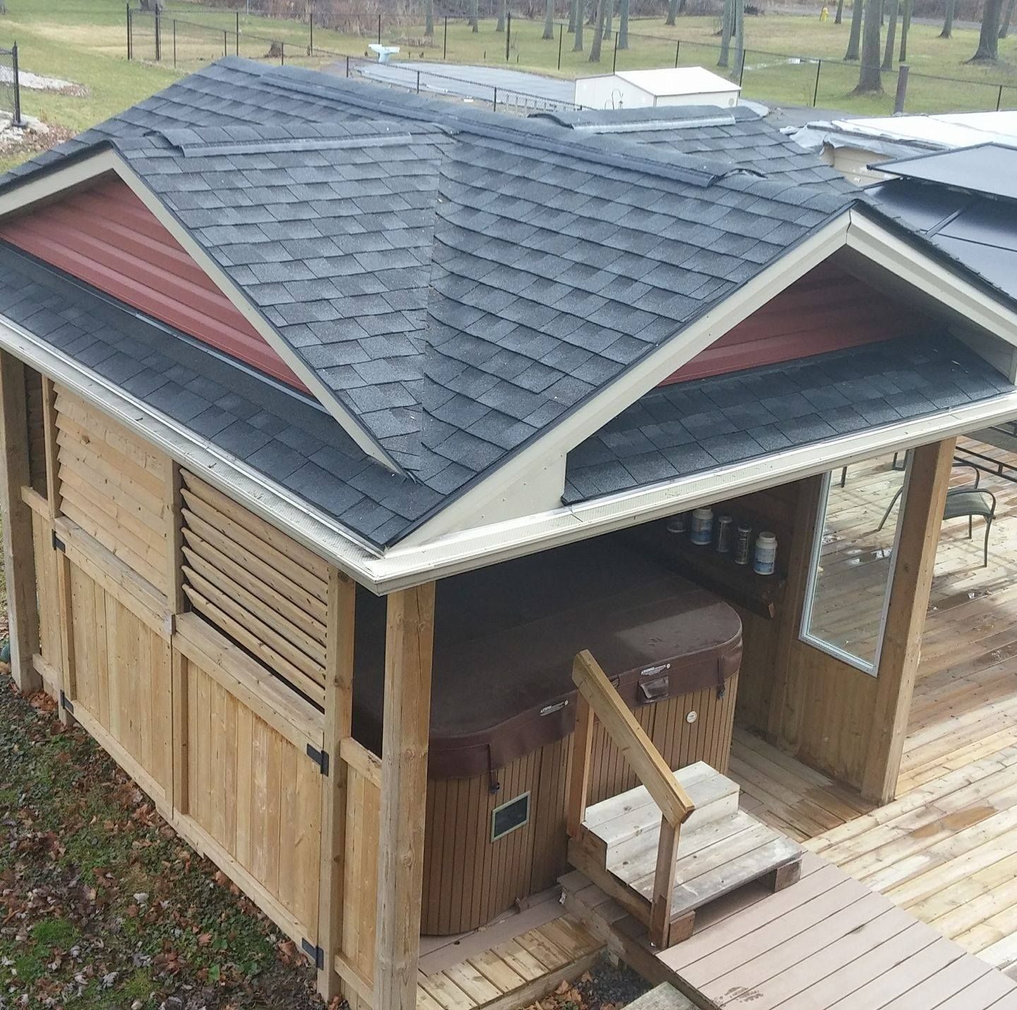 A gazebo with a hot tub underneath it