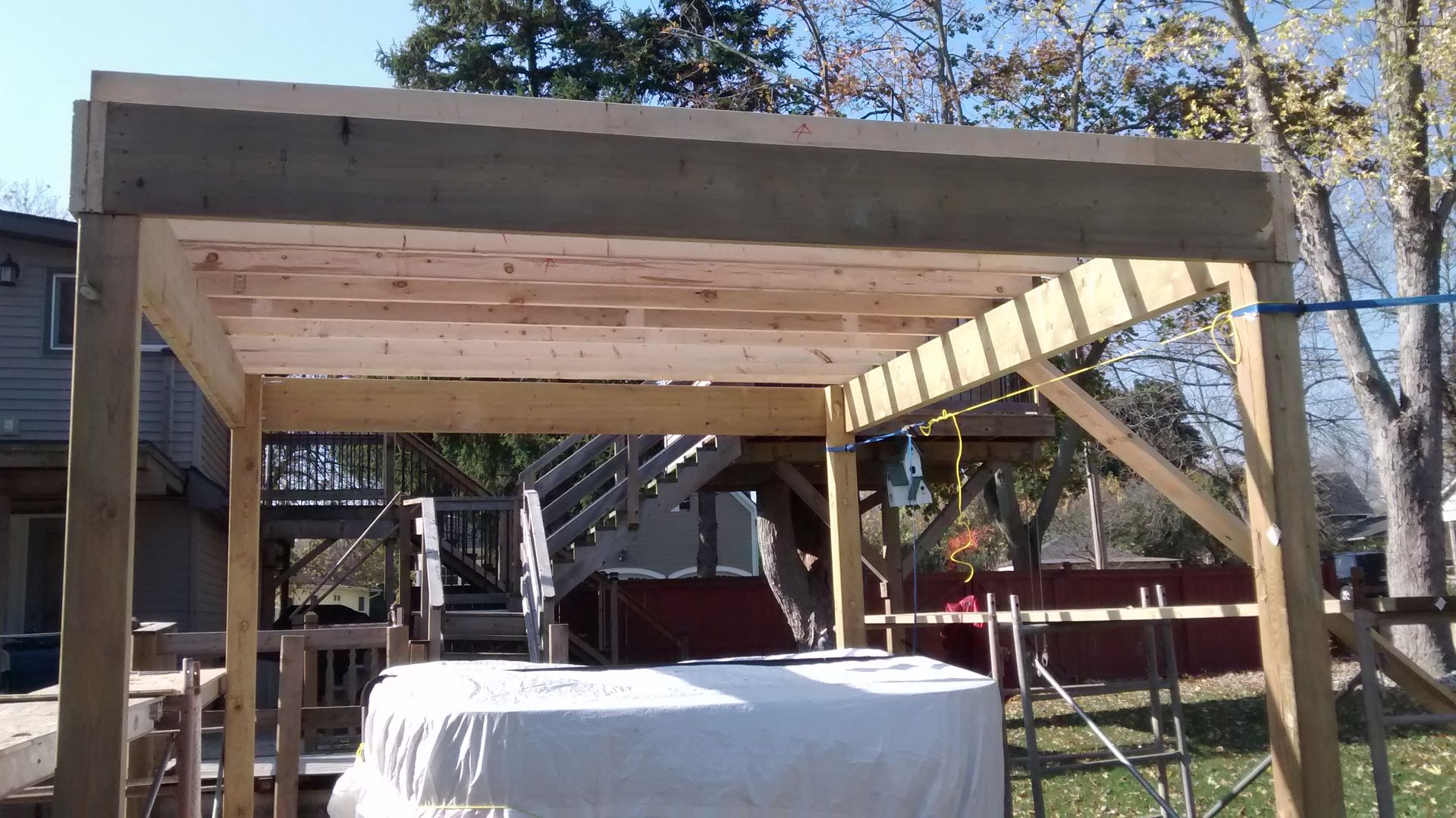 A wooden structure is being built in a backyard