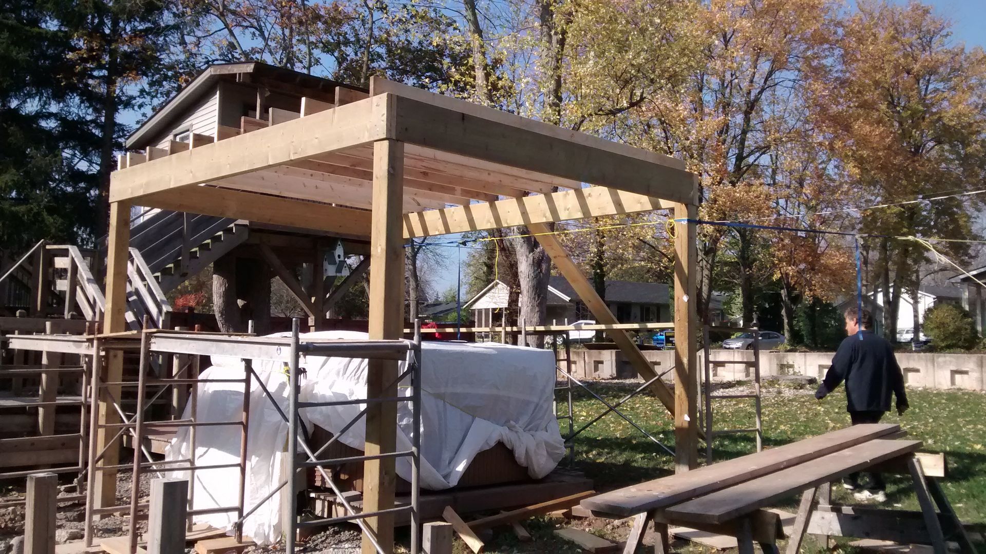 A man is standing in front of a building under construction