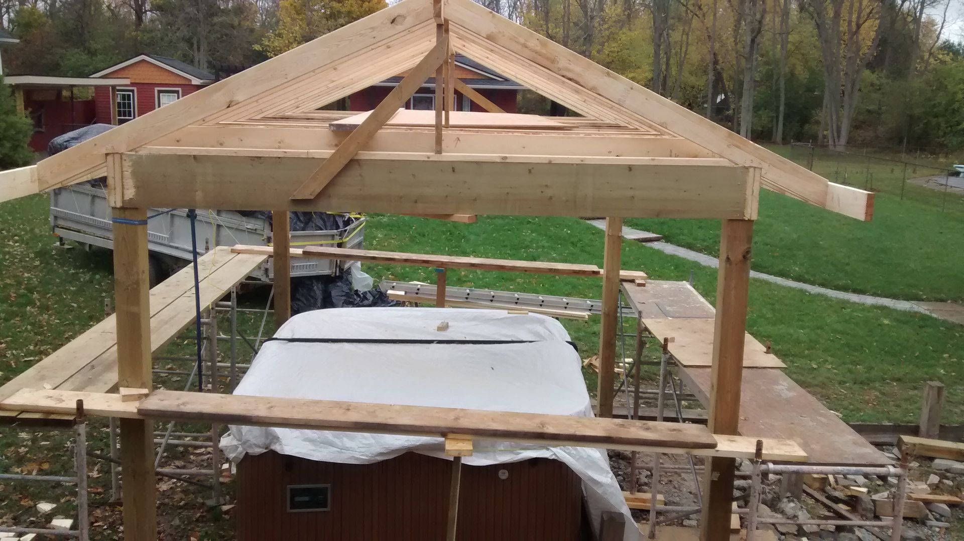 A wooden structure is being built over a hot tub