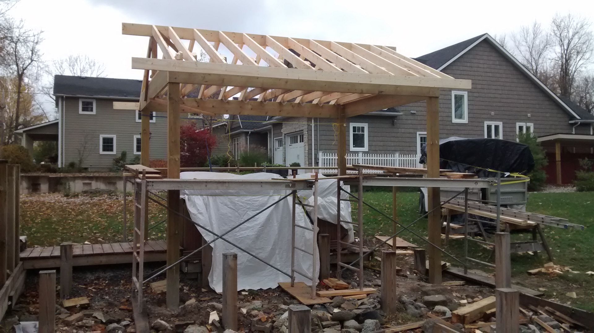 A wooden structure is being built in front of a house