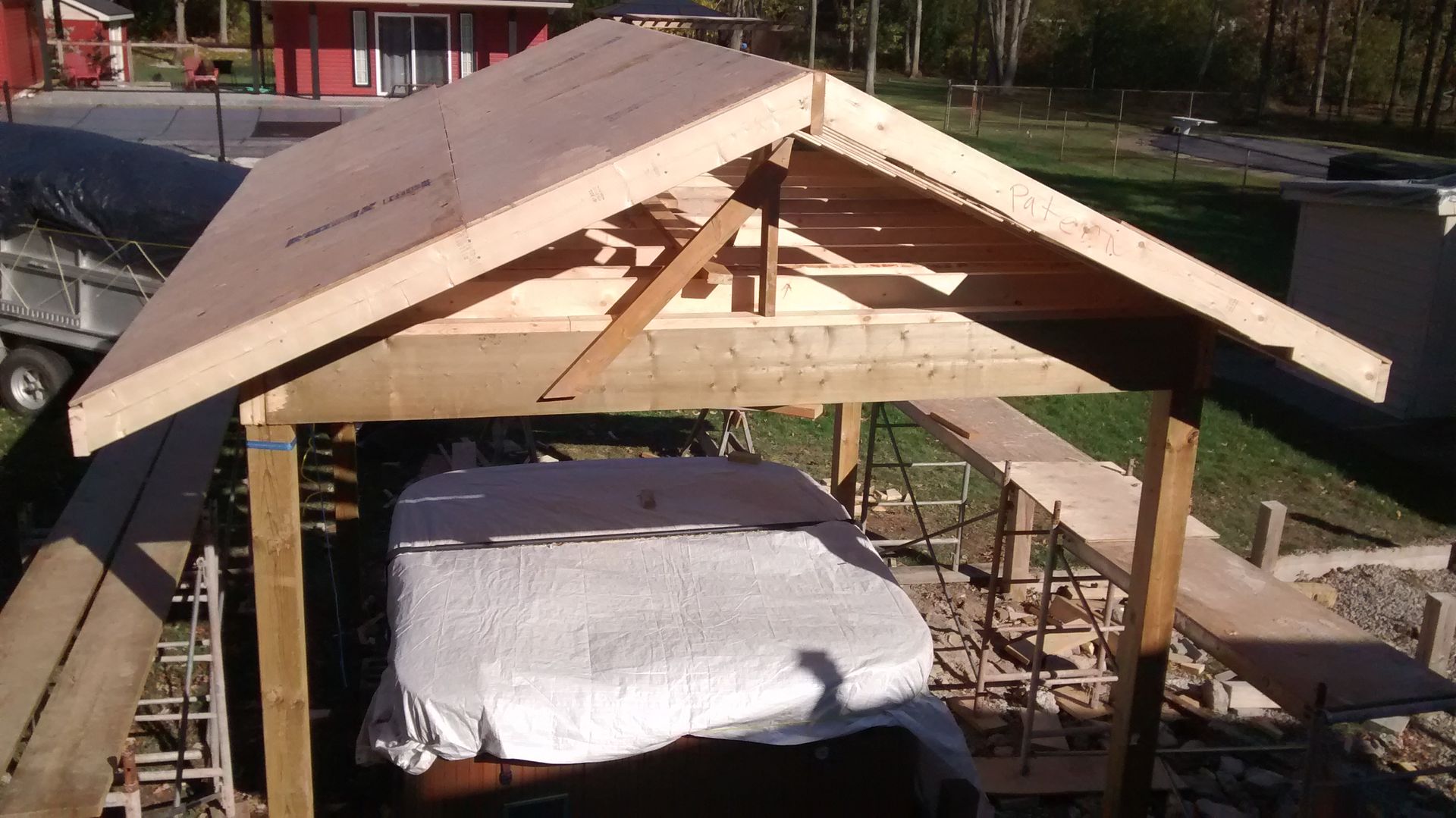 A wooden structure with a roof that is being built