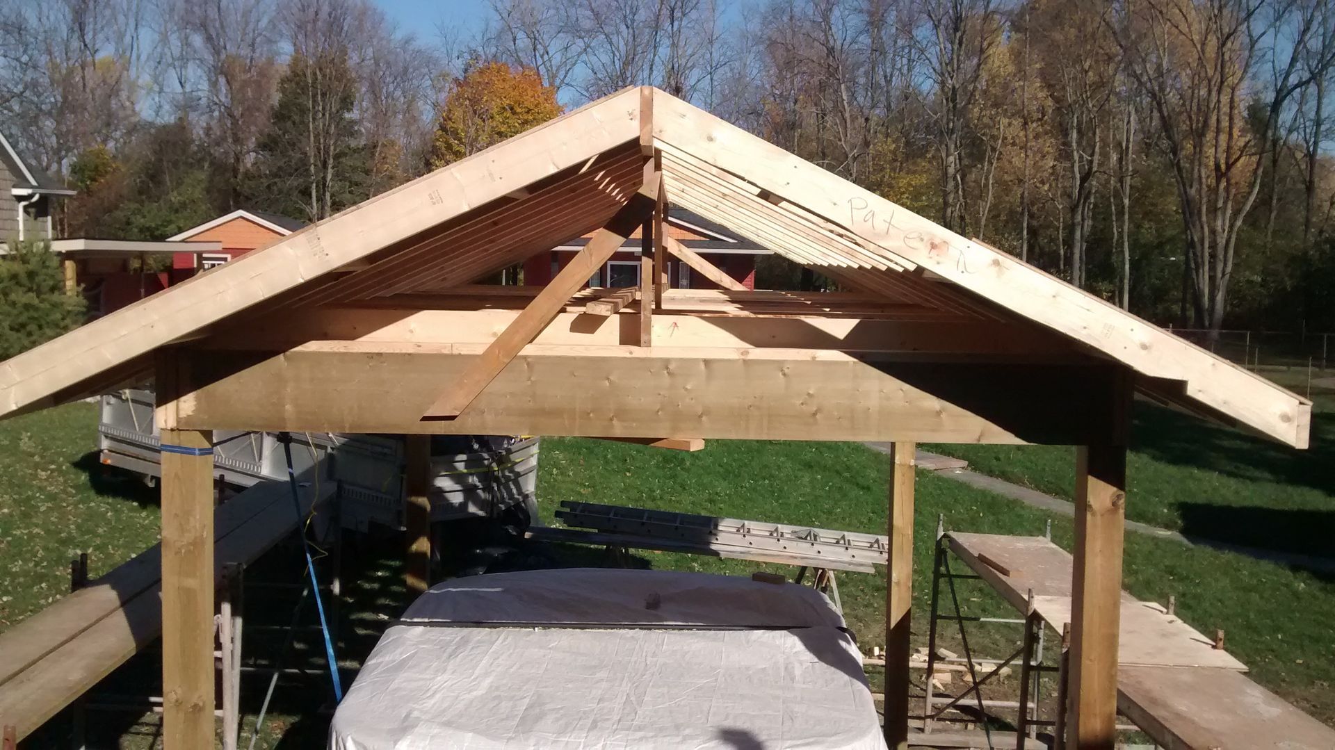 A wooden structure is being built over a hot tub