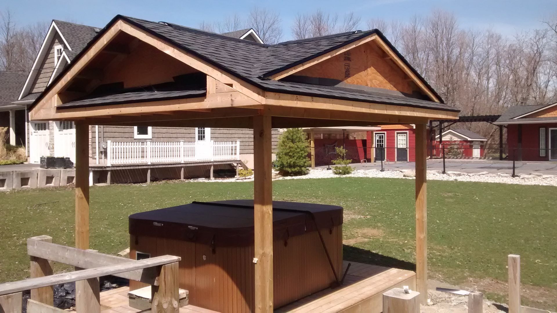 A gazebo with a hot tub underneath it