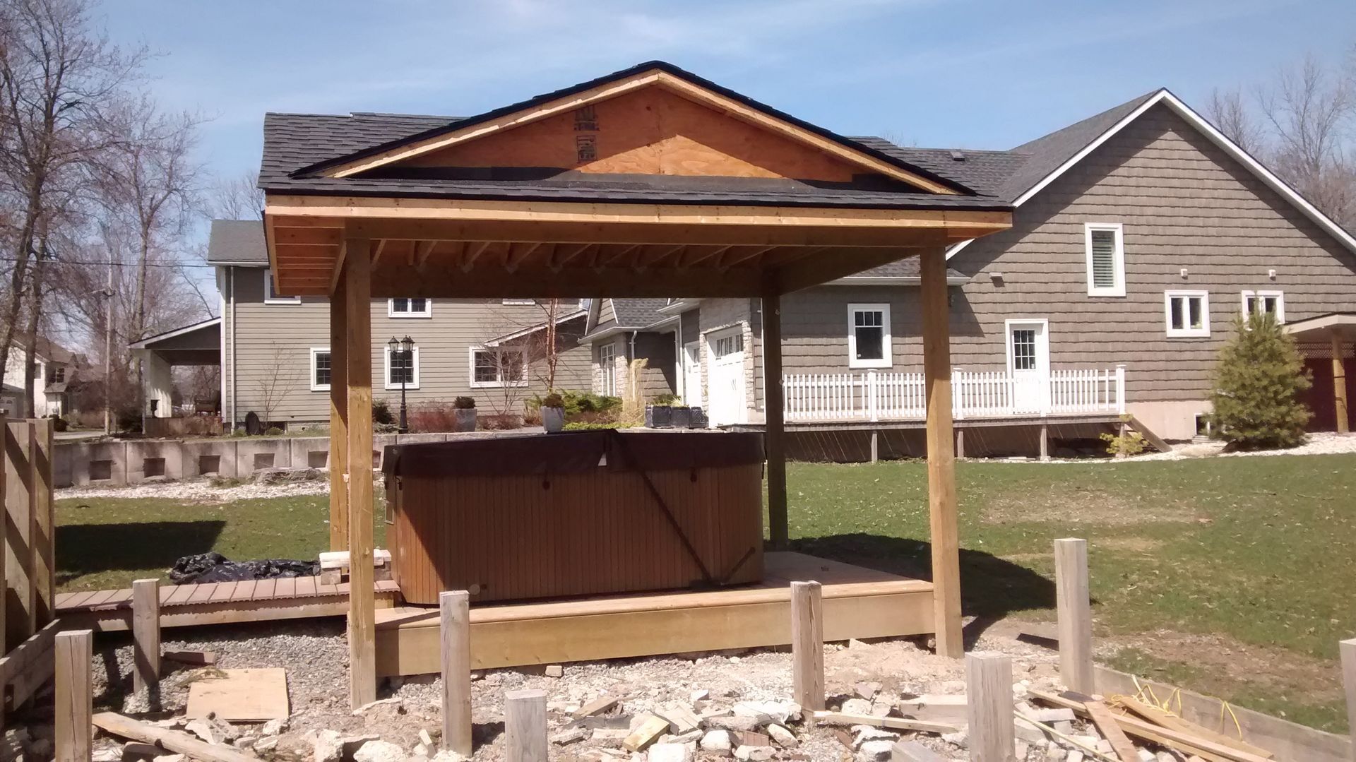 A gazebo is being built in front of a house