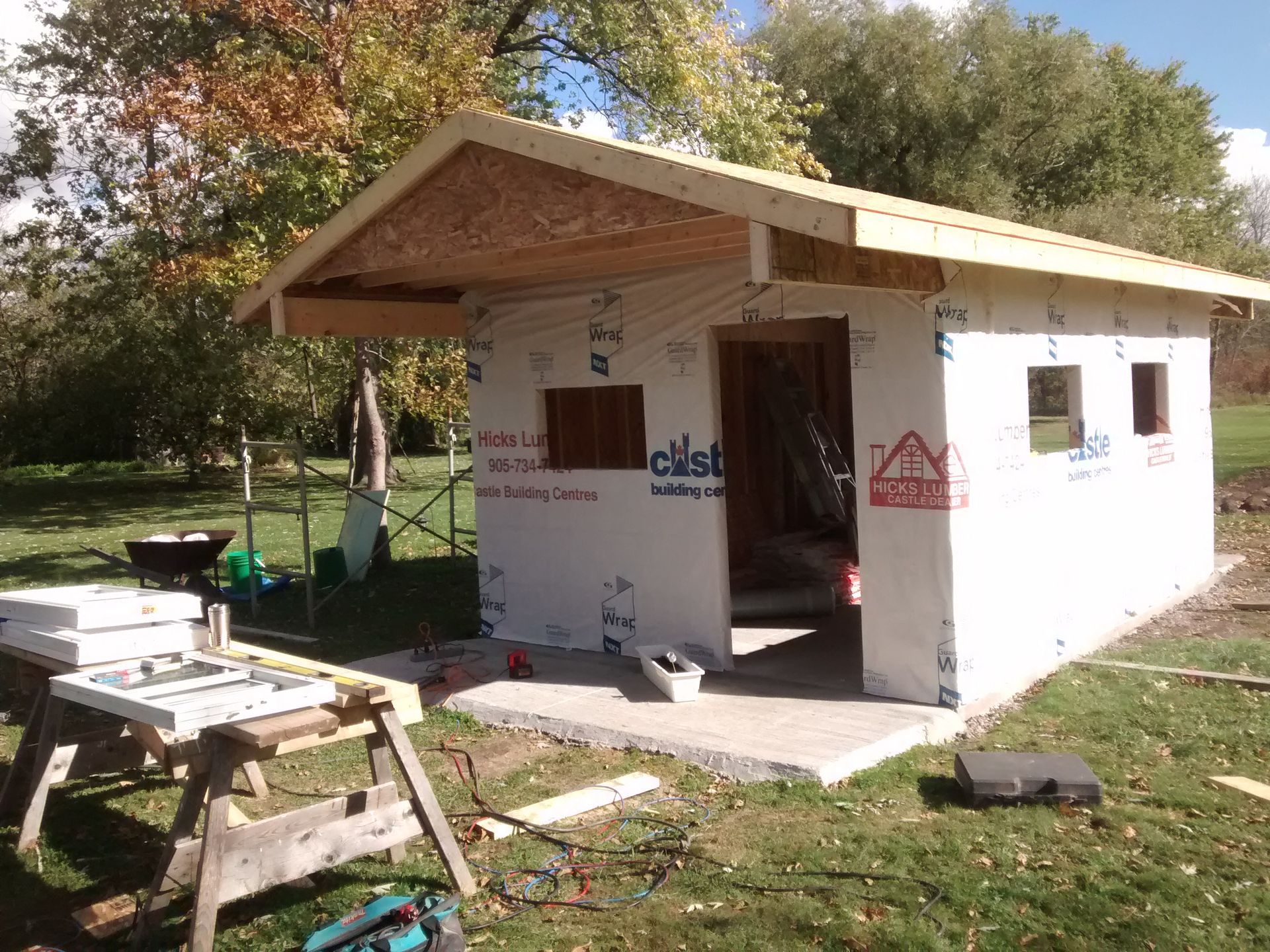 A small house is being built with a roof made of plywood