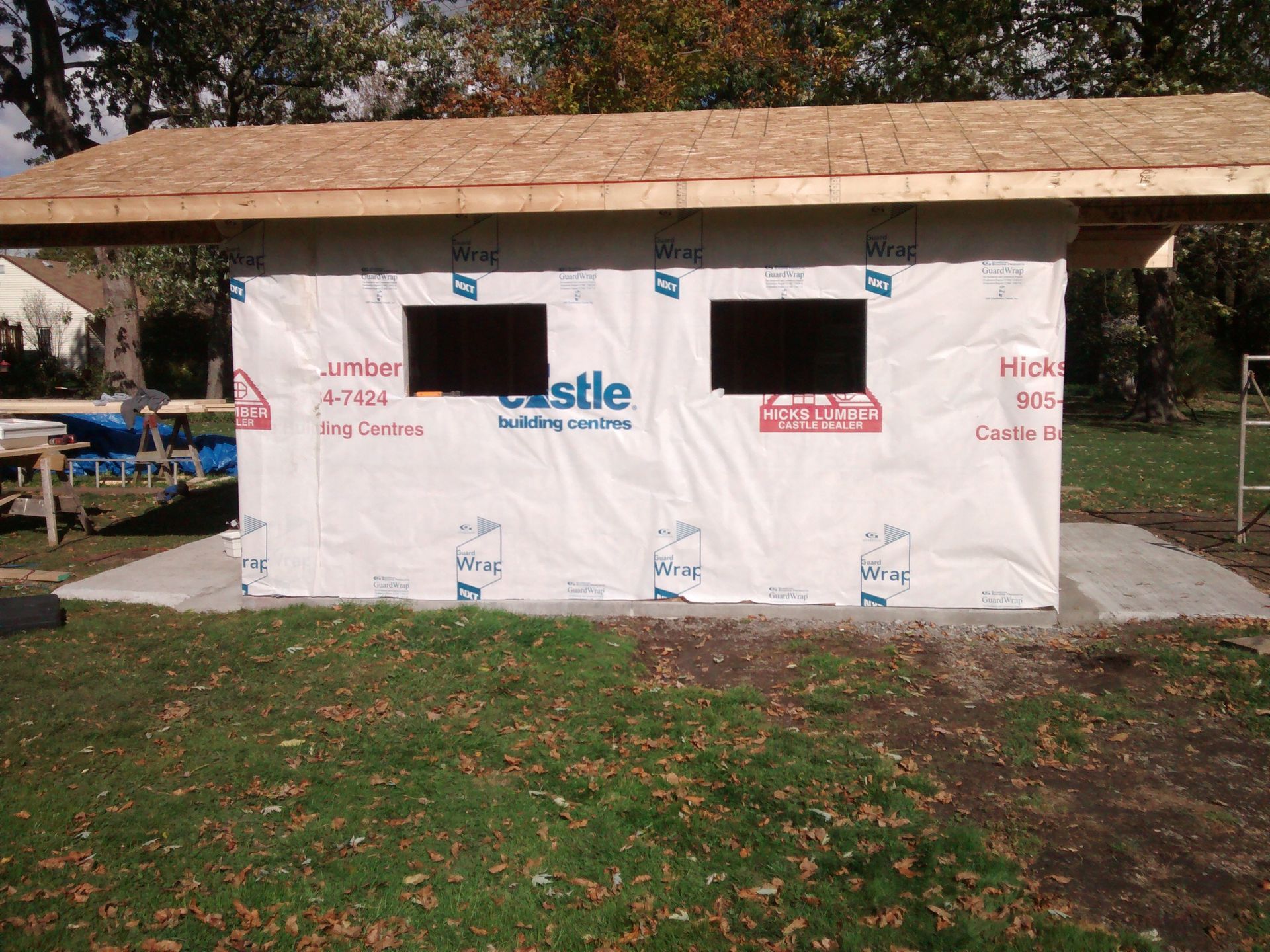 A building under construction with castle wrap on the side