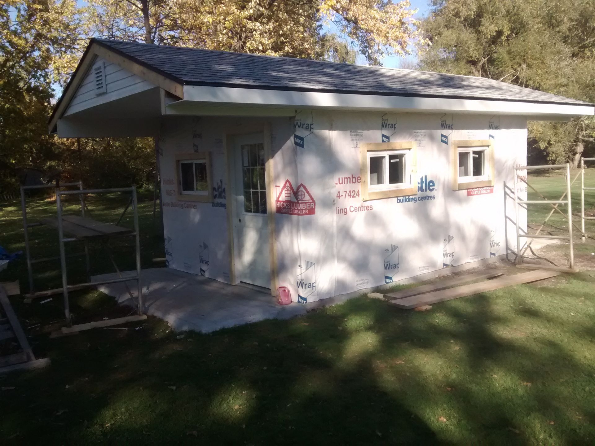 A small white house is being built in the backyard.