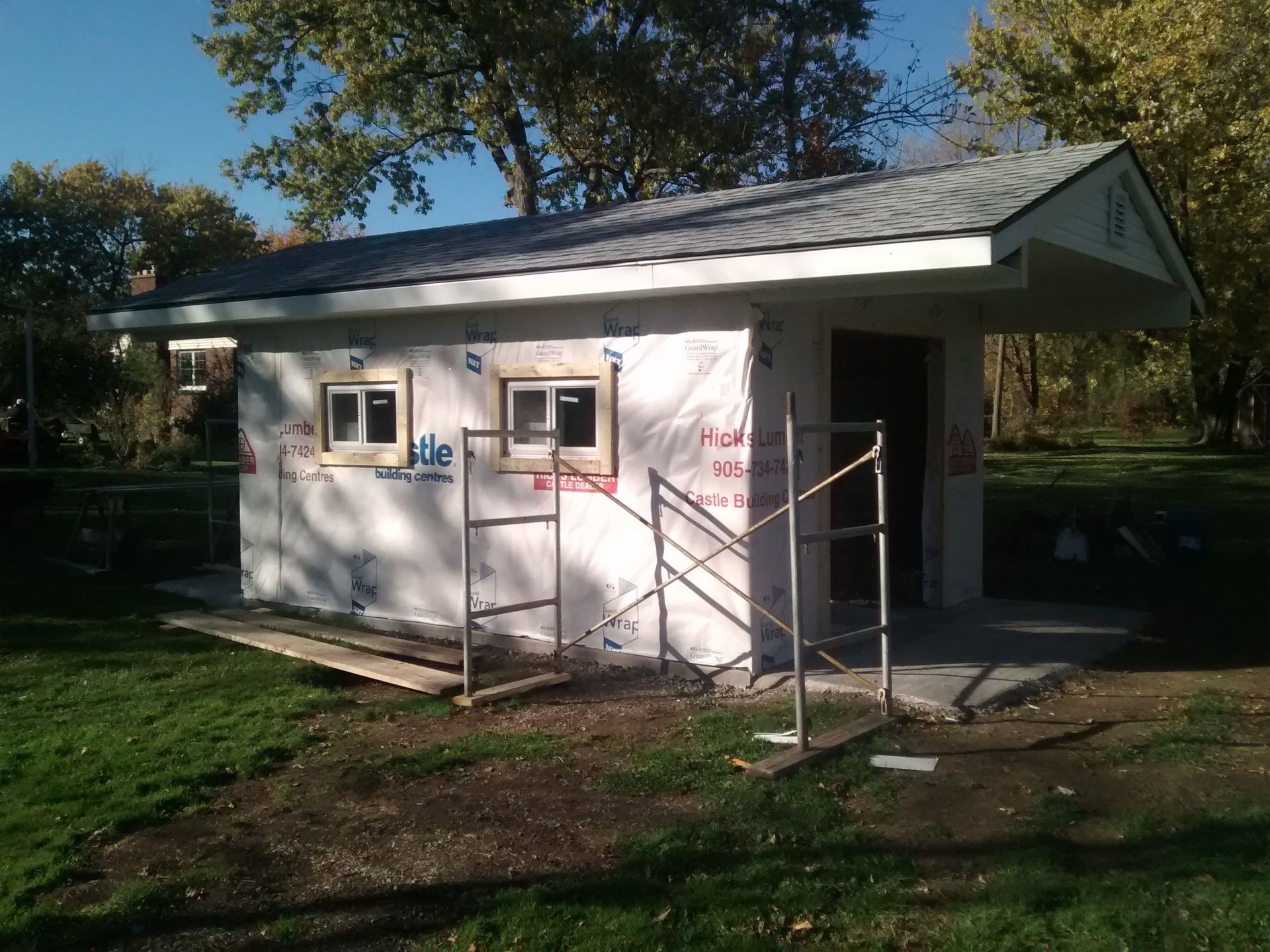 A small house is being built in a park