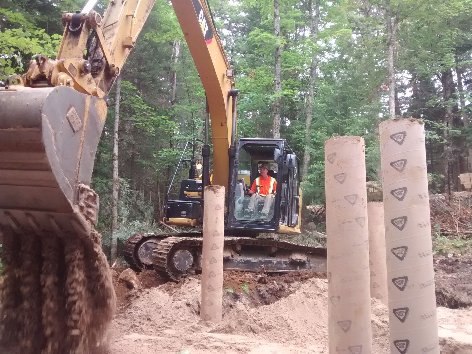 A man is driving a bulldozer in the woods