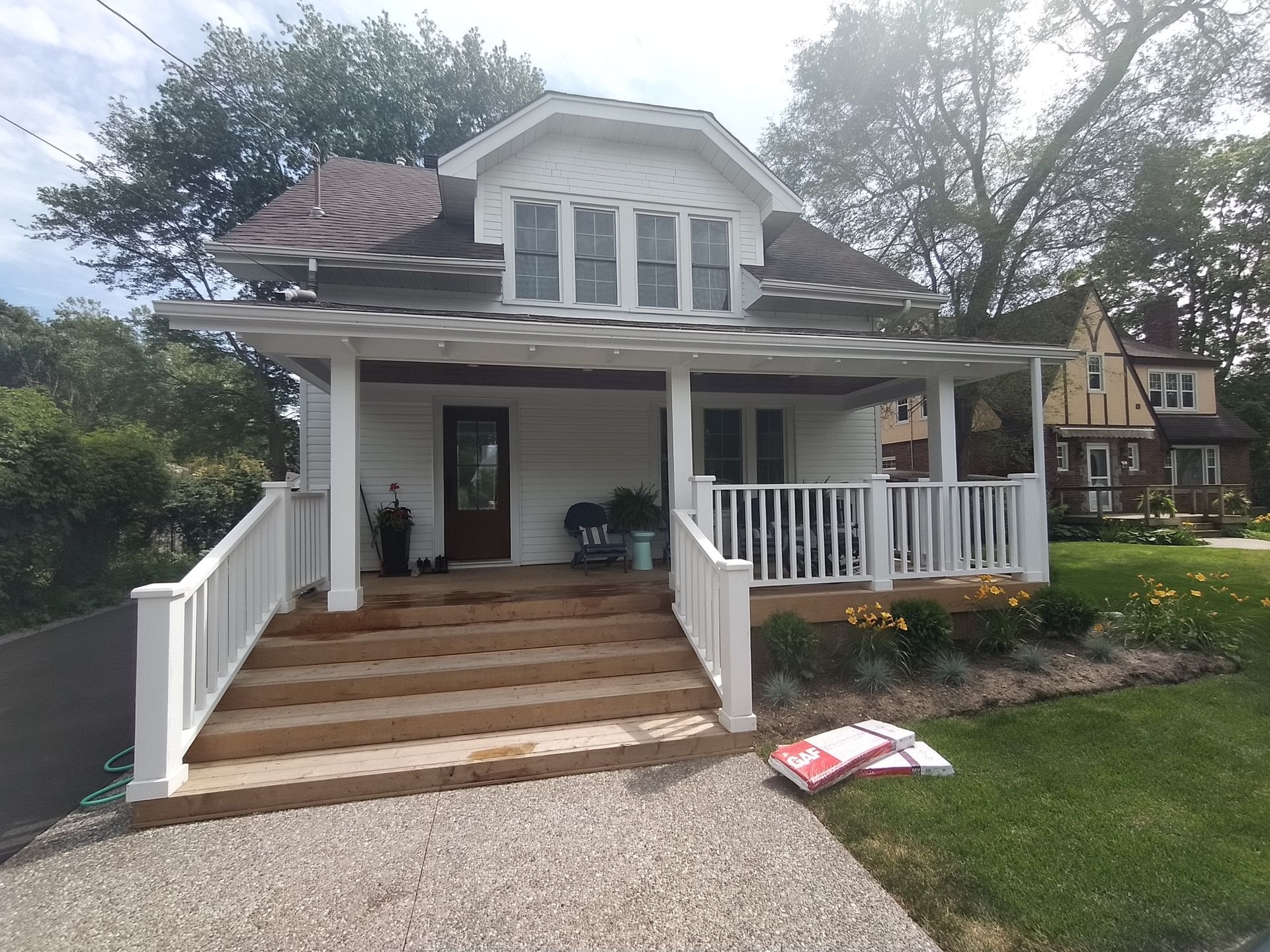 A white house with a porch and stairs