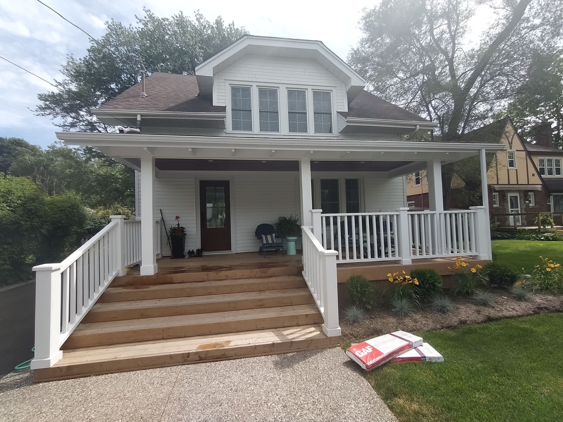 A white house with a porch and stairs