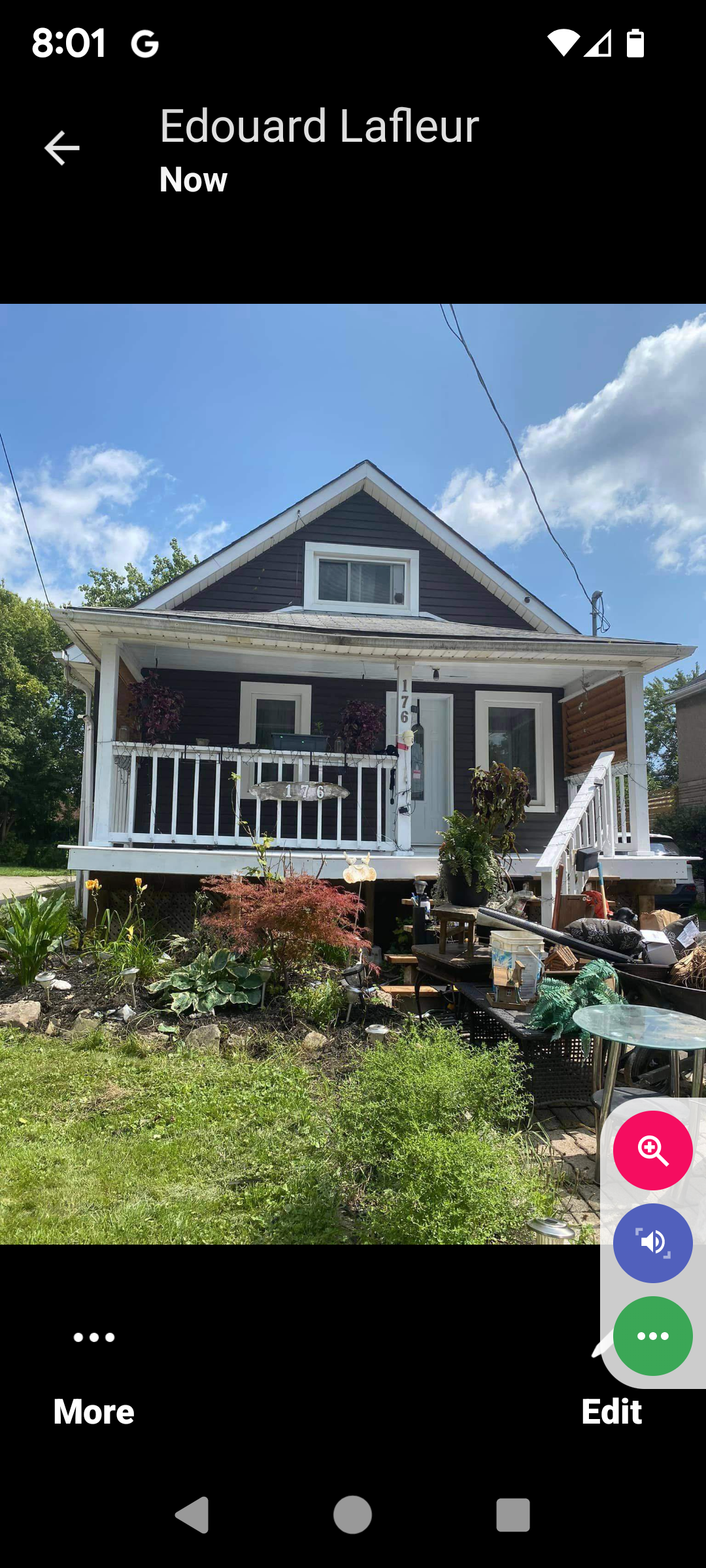 A picture of a house with a porch on a cell phone.