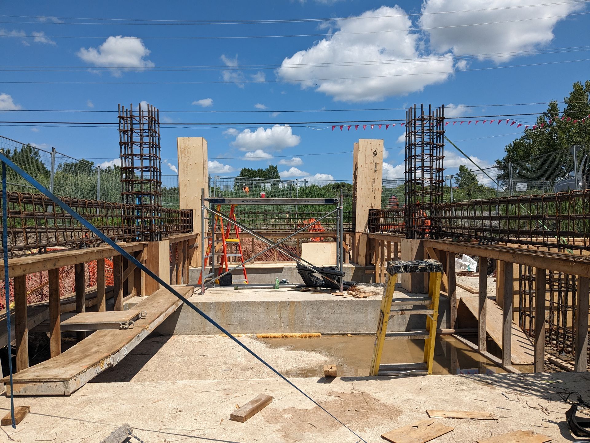 A construction site with a blue sky and clouds in the background