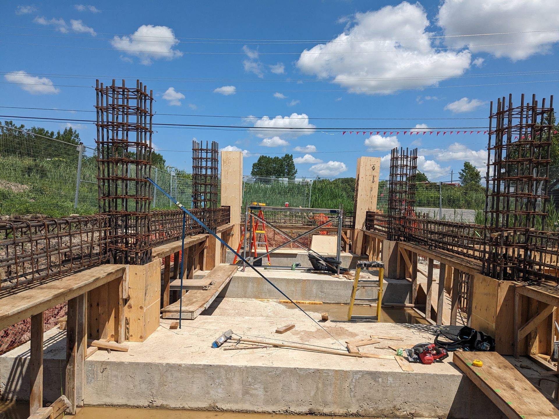 A construction site with a blue sky and clouds in the background.