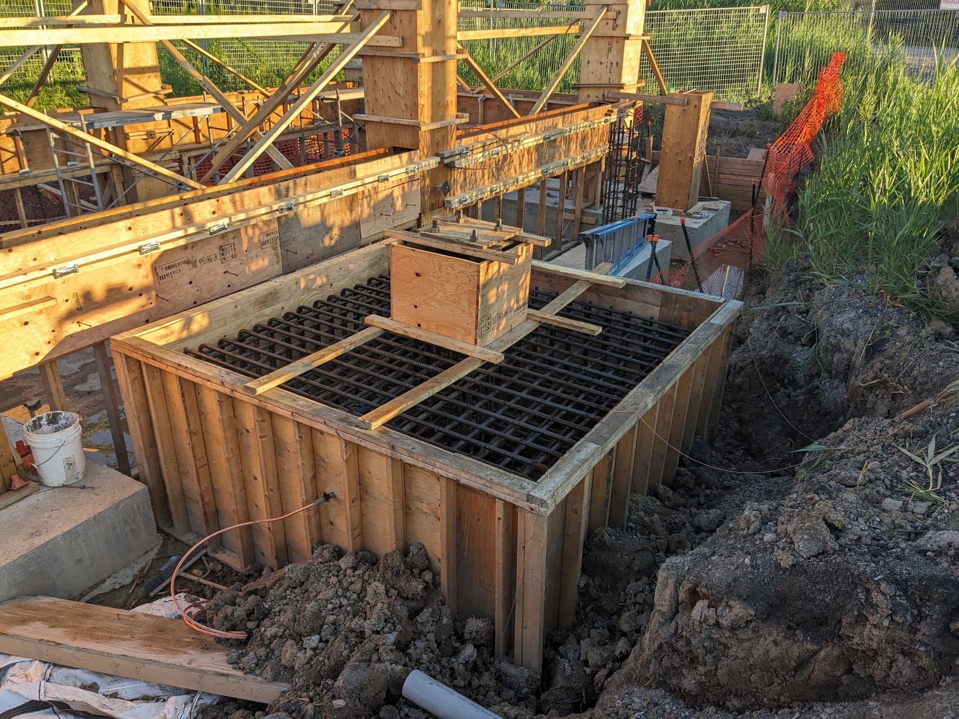 A large wooden box is sitting on top of a pile of dirt.