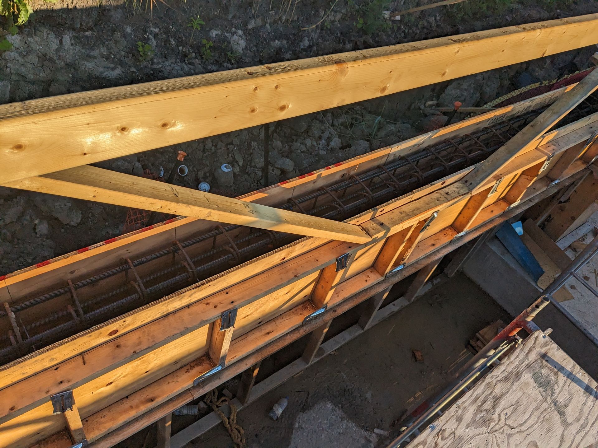 A large wooden structure is being built on a construction site.