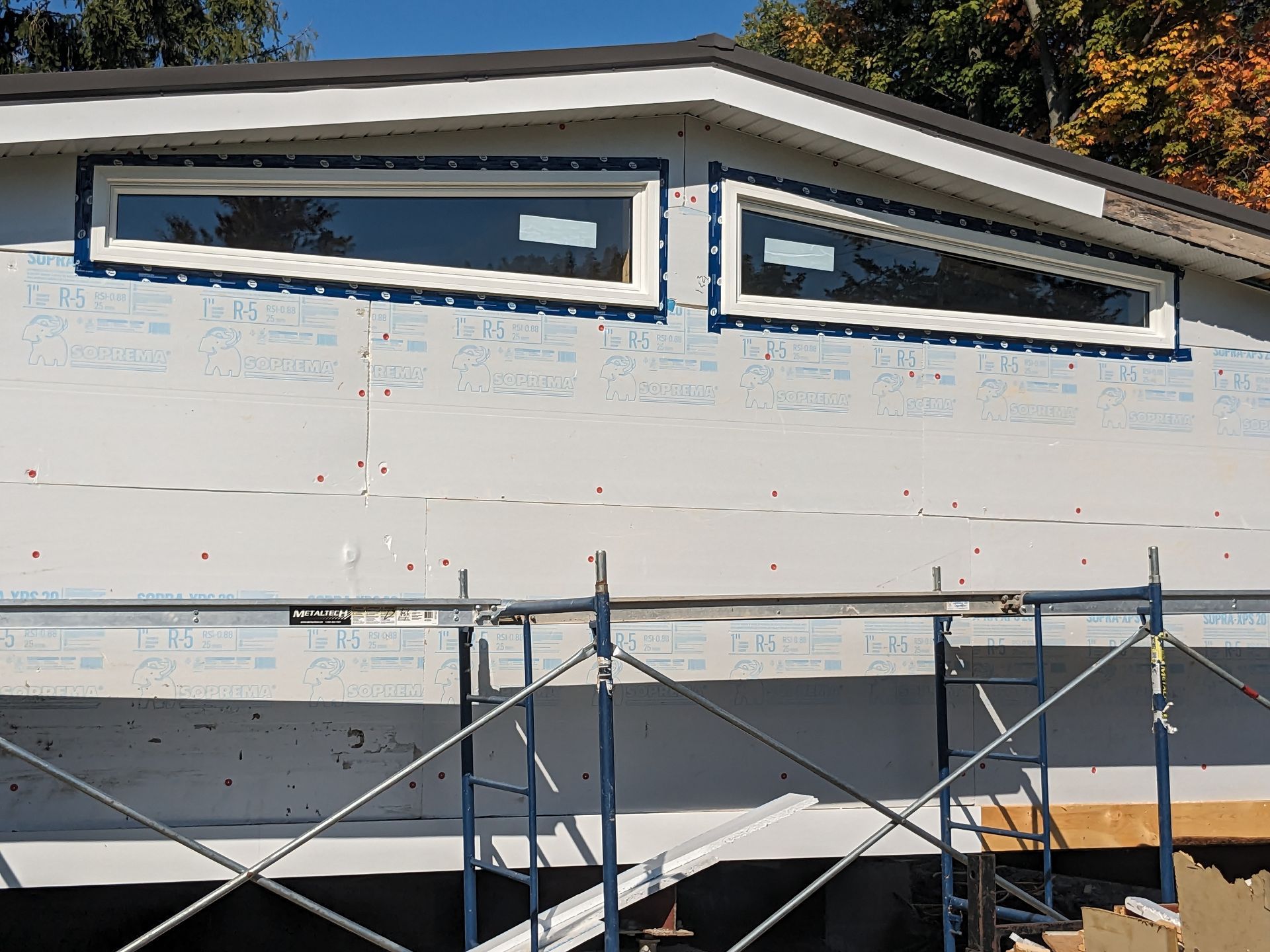 A house is being built with scaffolding around it.