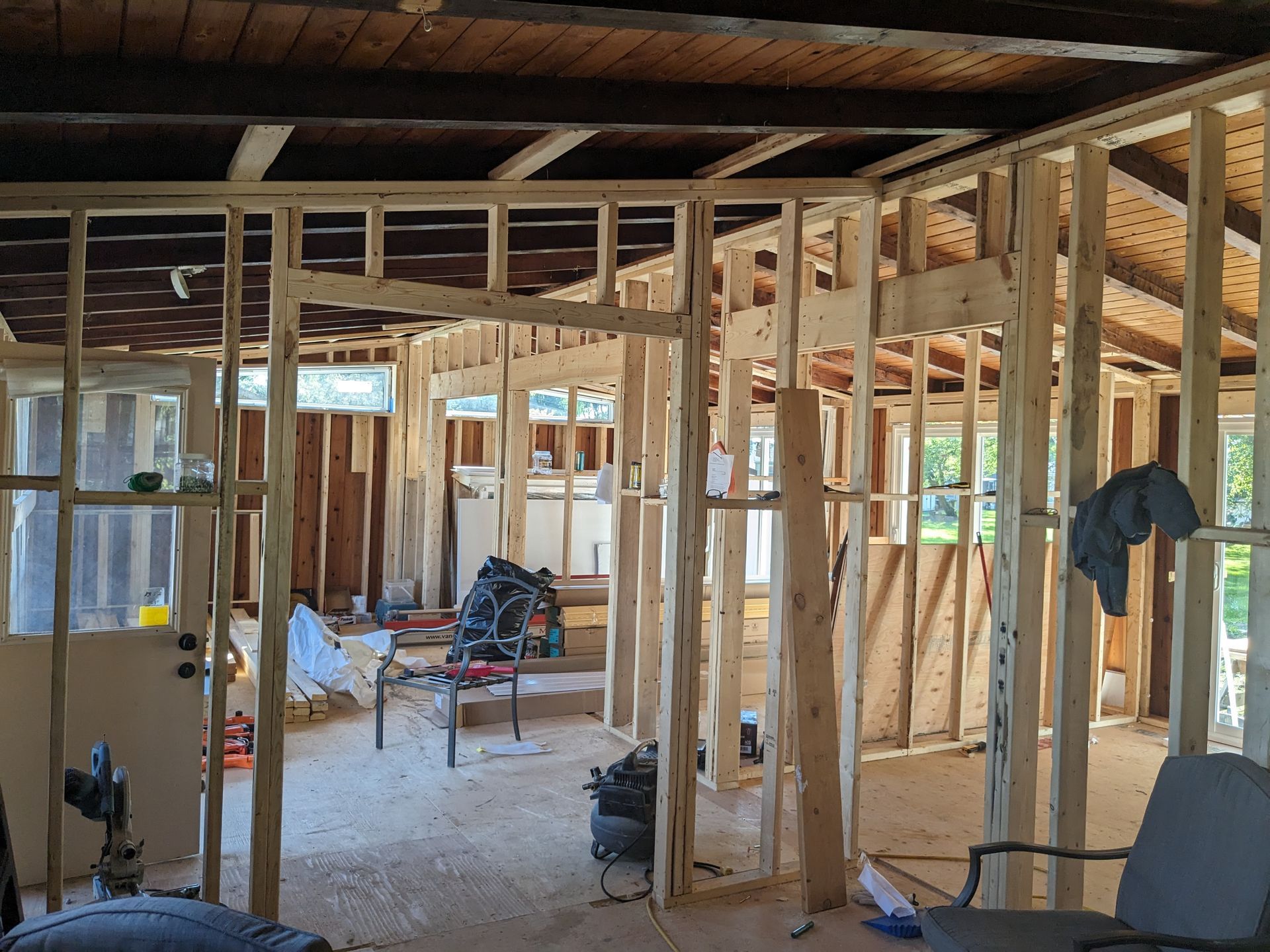 A room with a lot of wooden walls and a chair in it.