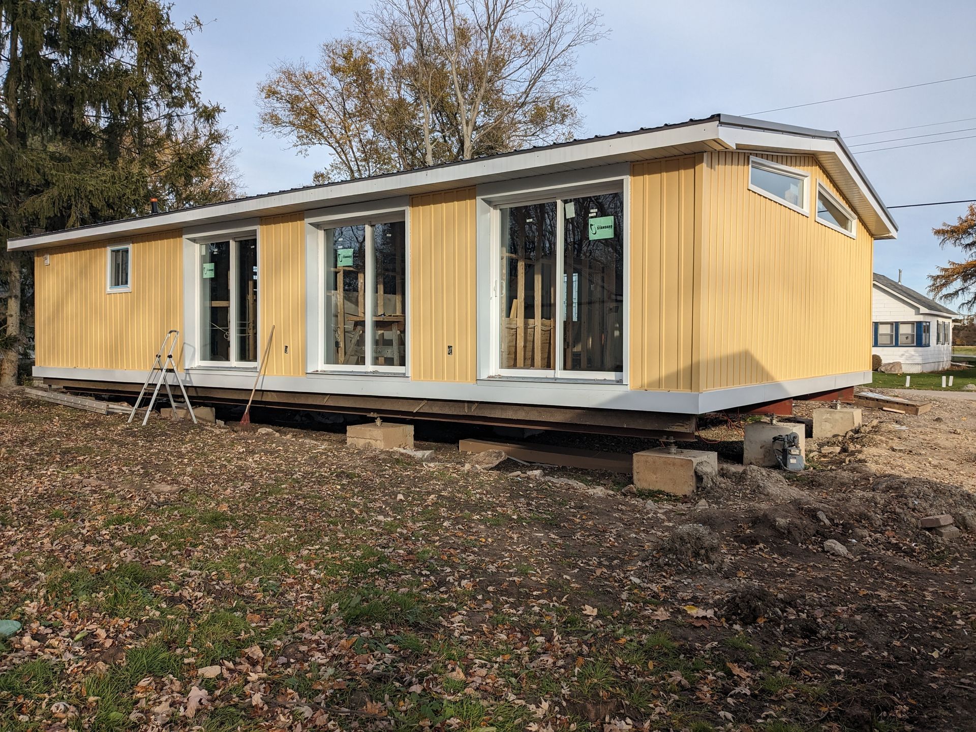 A mobile home is sitting on top of a dirt field.