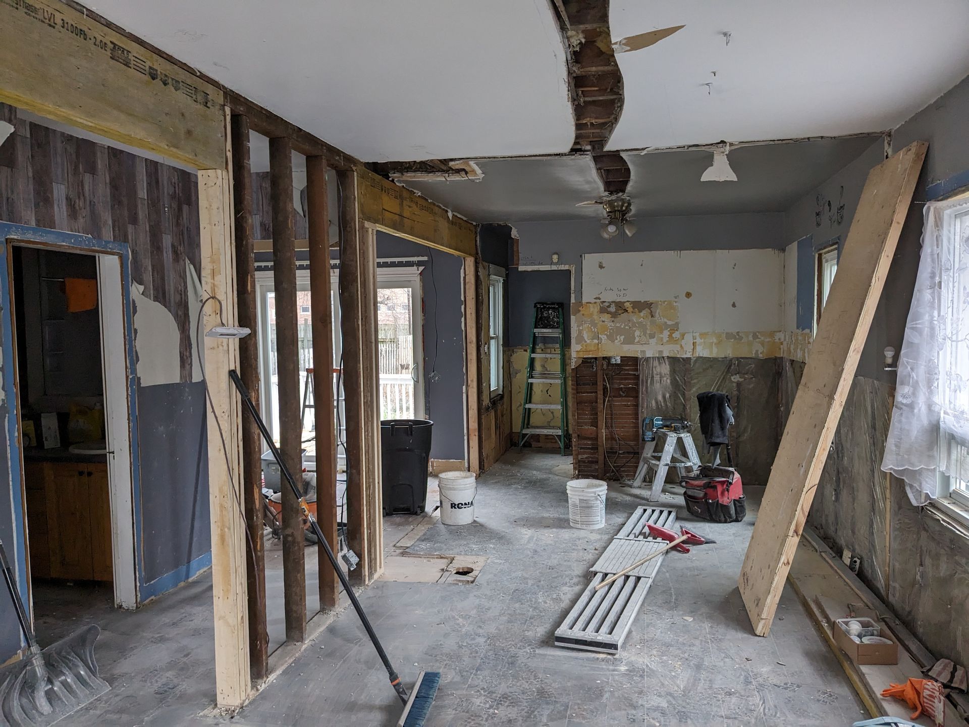 A house is being remodeled with a broom in the middle of the room.