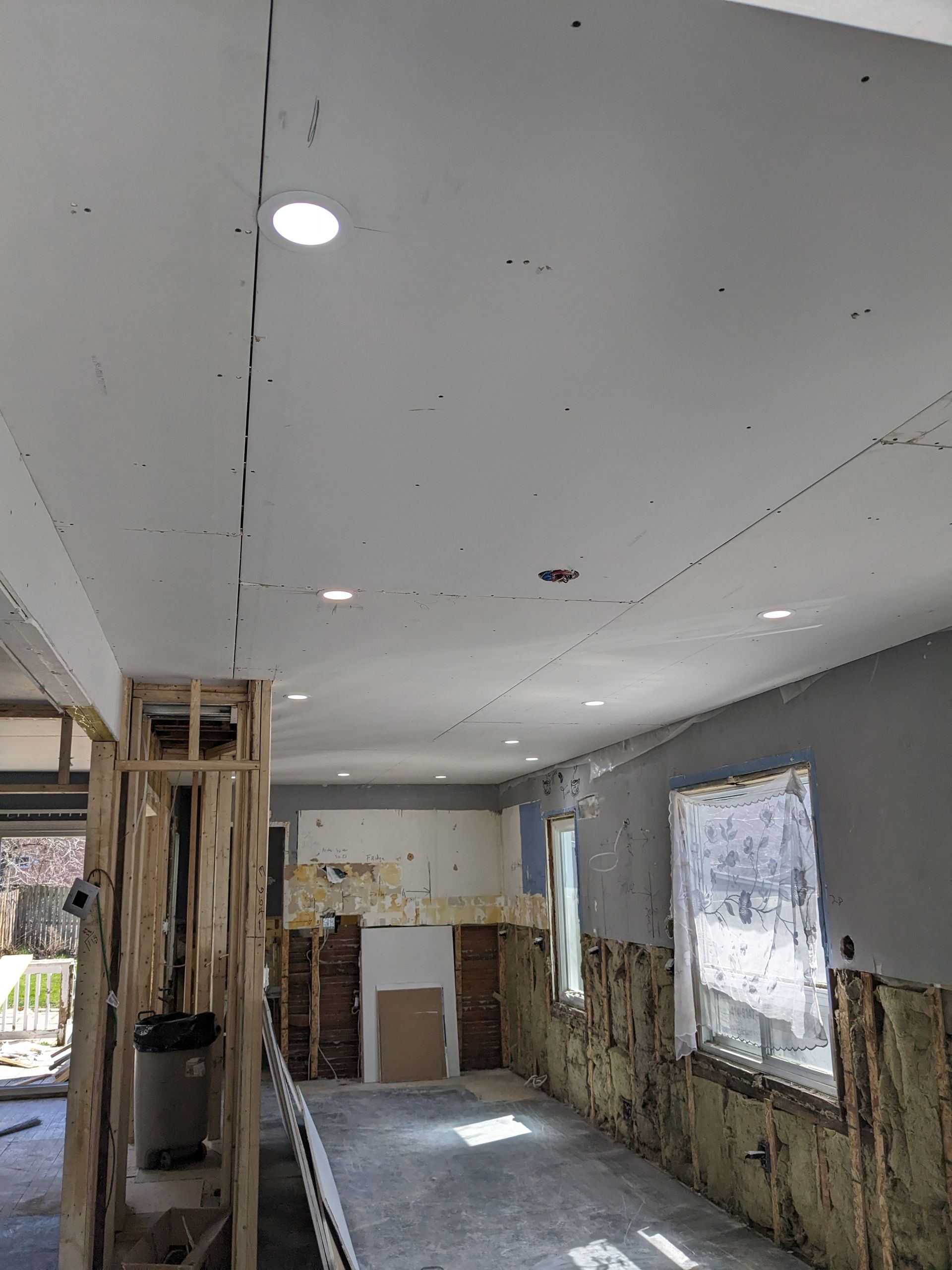 A large room with a ceiling that is being remodeled.