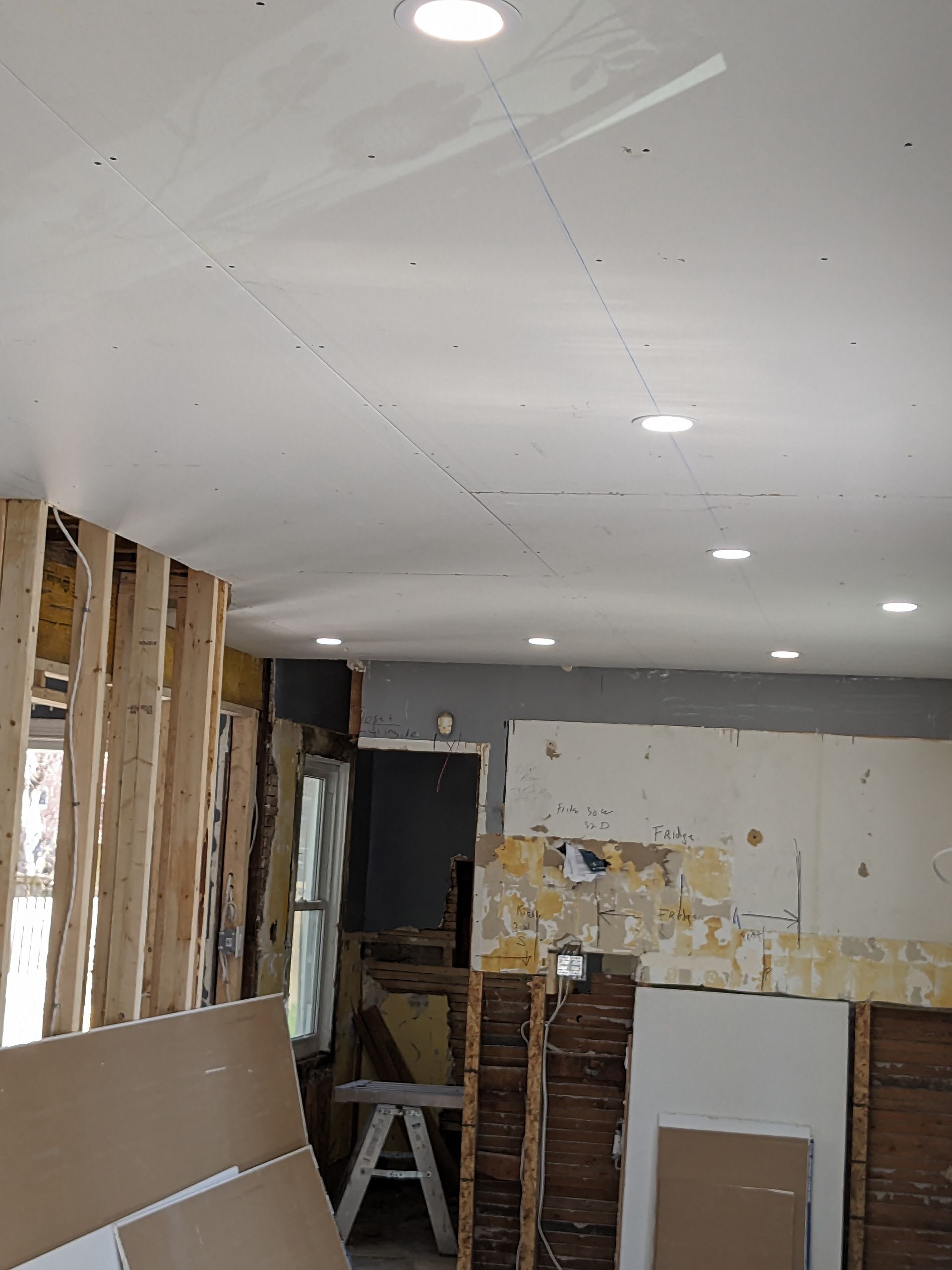 A room that is being remodeled with a lot of boxes on the floor.