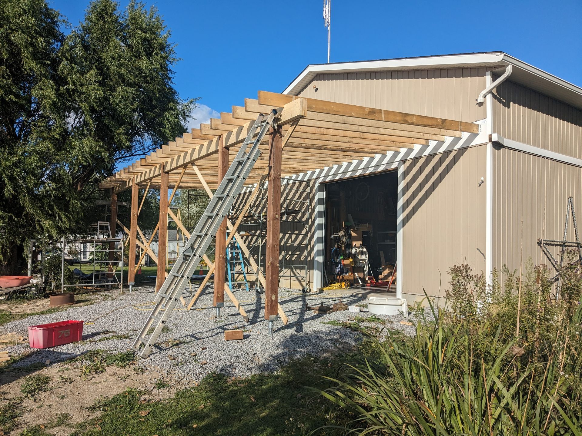 A wooden structure is being built on top of a garage.