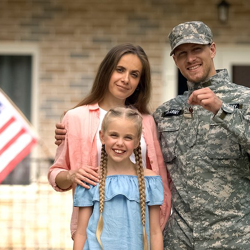 Military family with keys to a new home
