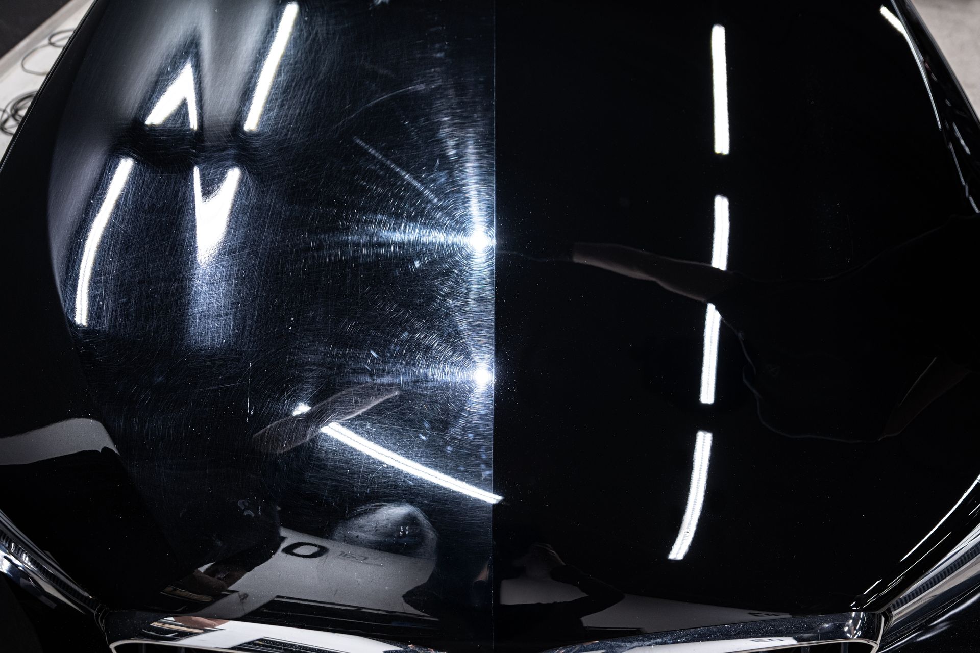 A car hood showing a split-screen comparison: the left side has paint swirl marks, and the right side is polished smooth.