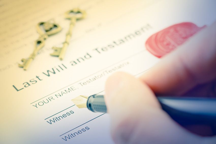 A Person is Signing a Last Will and Testament With a Pen — Budd & Piper Solicitors & Conveyancers in Tweed Heads, NSW