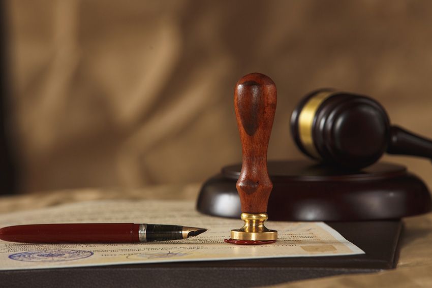 A Pen on Top of a Piece of Paper Next to a Judge 's Gavel — Budd & Piper Solicitors & Conveyancers in Tweed Heads, NSW