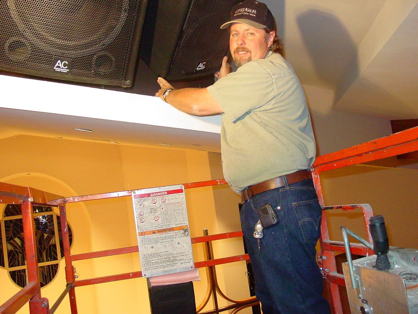 A man is standing on a ladder.