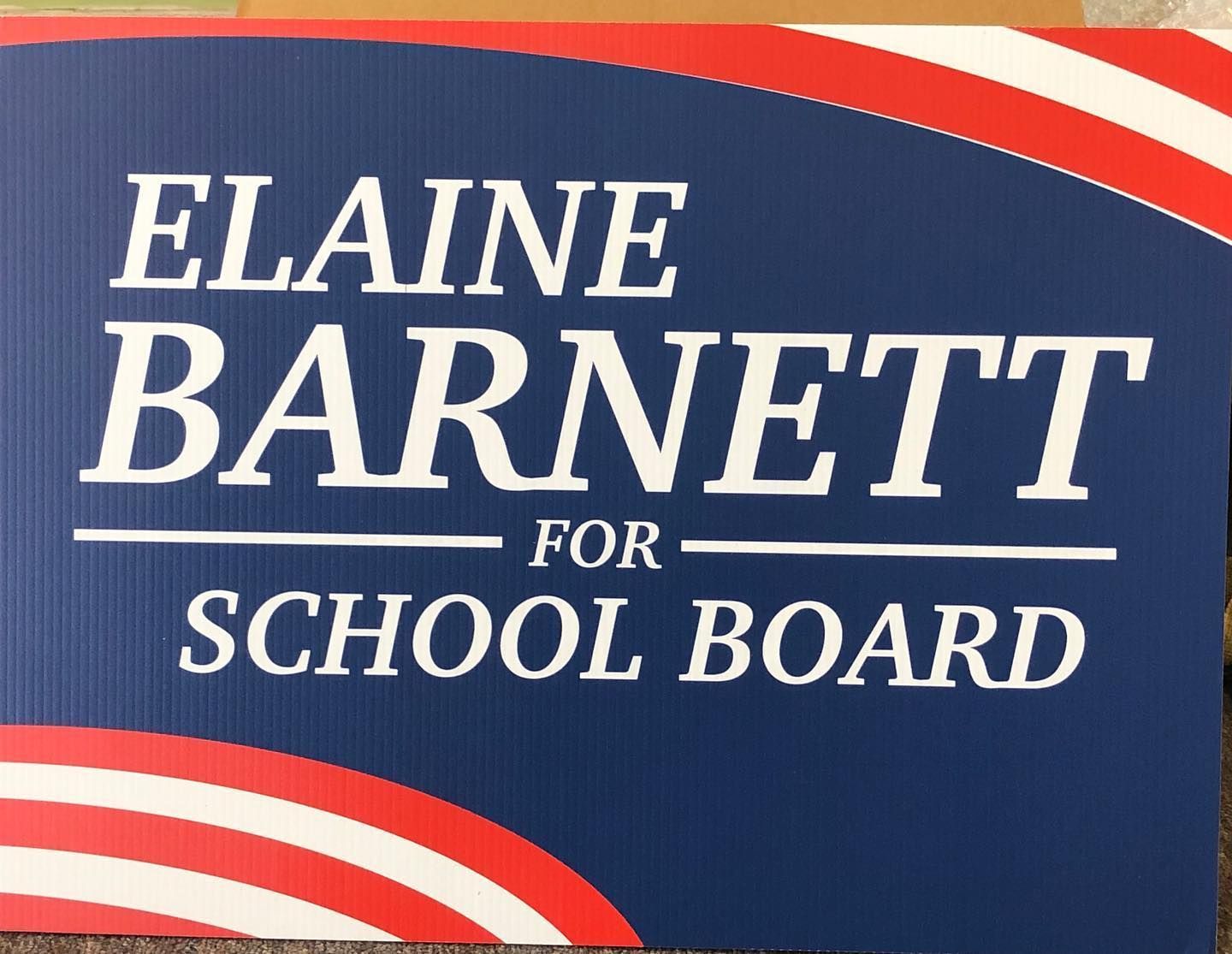 A blue sign that says elaine barnett for school board