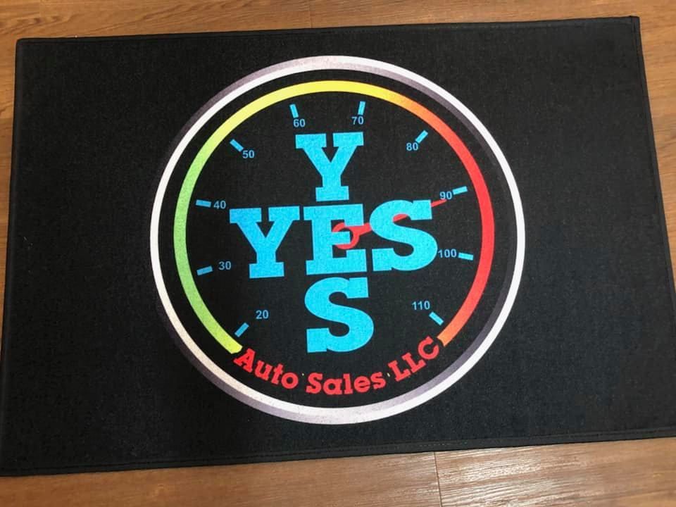 A black mat with a logo for y yes auto sales llc