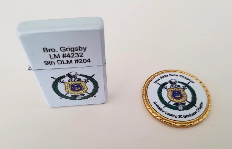 A lighter and a coin with the name bro griggsby on them