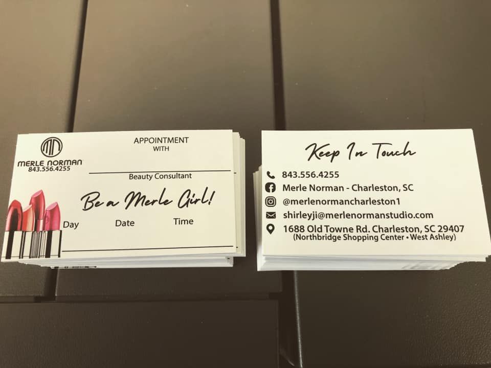 A stack of business cards with lipstick on them