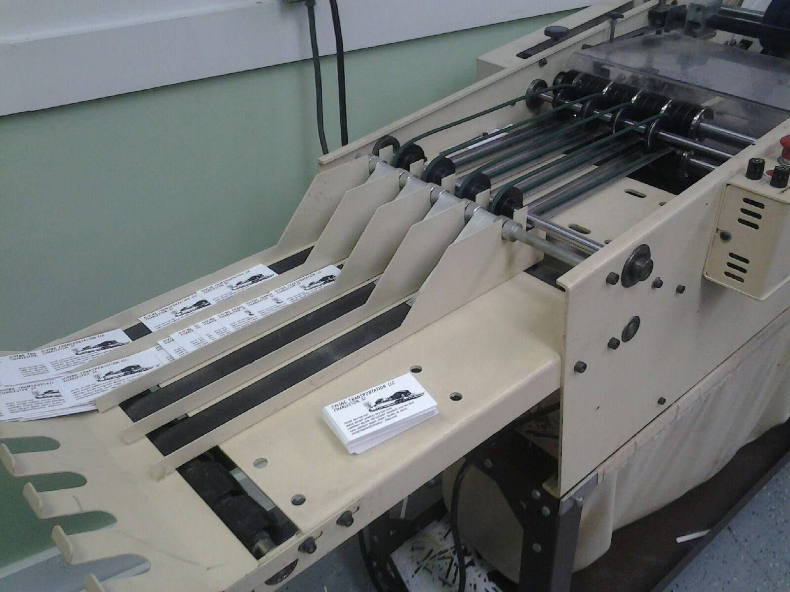 A machine that looks like a snowboard is being used to make cards