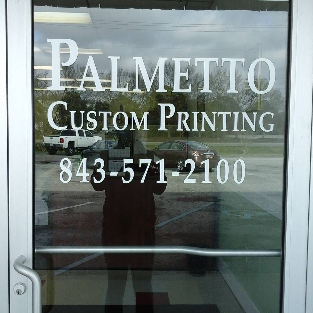 A palmetto custom printing sign on a glass door