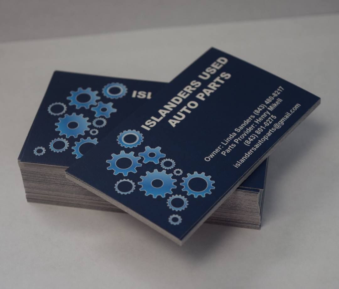 A stack of business cards for islanders used auto parts
