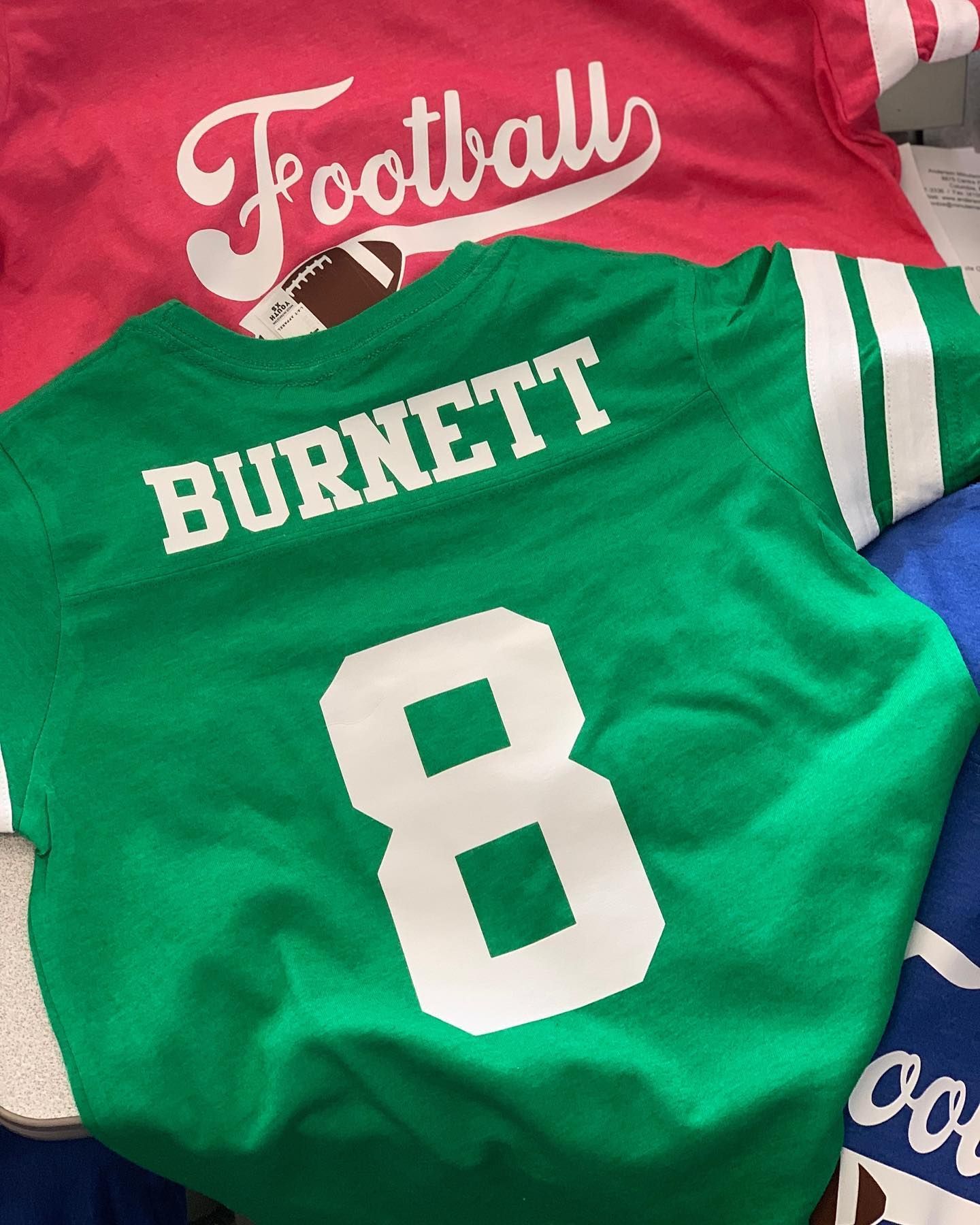 A green jersey with the name burnett on it