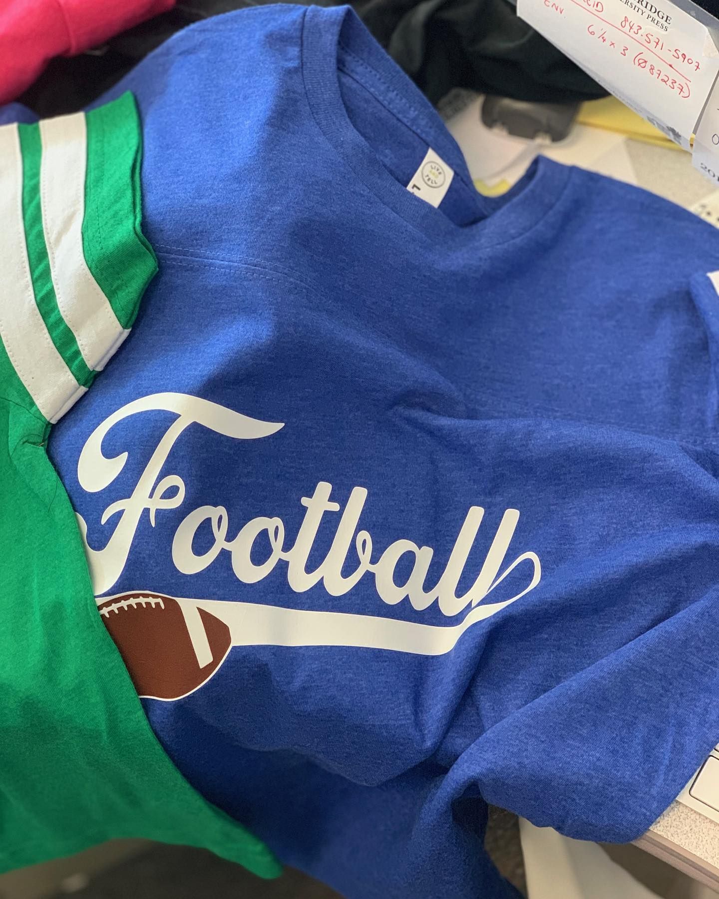 A blue shirt with the word football on it
