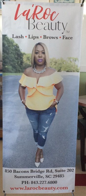 A woman in a yellow off the shoulder top is on a banner for laroc beauty