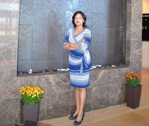Dr. Priyanka Sharma stands in front of a wall