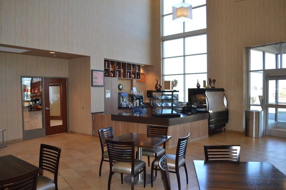 A restaurant with tables and chairs and a counter